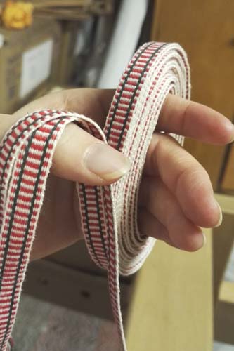 Etelä-Pohjanmaan naisen tarkistettu kansallispuku, pirtanauha, käsinkudottu